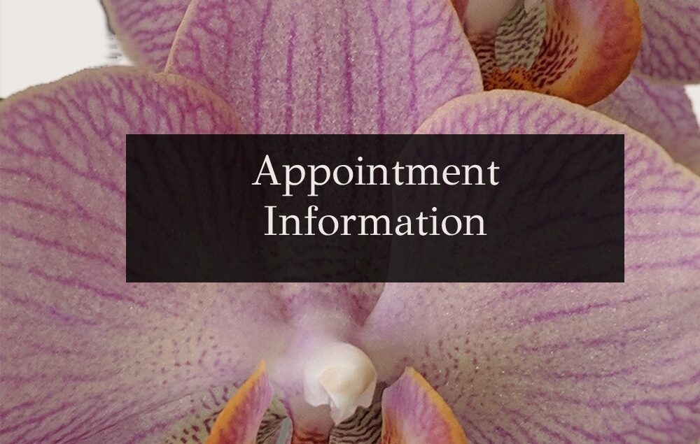 an orchid behind a dark rectangle with appointment information written